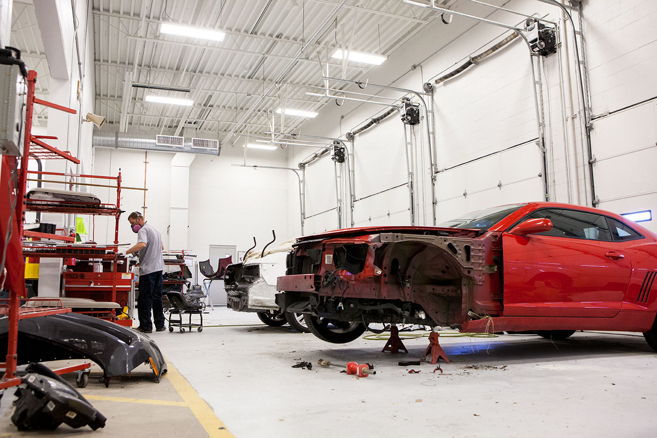 Auto body estimator reviewing vehicle repair paperwork